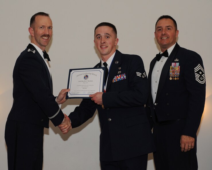 Senior Airman Charles Sweeney, 2nd Civil Engineer Squadron, receives an Airman Leadership School graduation certificate from Col. Leland Bohannon, 2nd Bomb Wing vice commander, during the ALS Class 14-3 Graduation on Barksdale Air Force Base, La., March 27, 2014. (U.S. Air Force photo/Senior Airman Benjamin Gonsier)