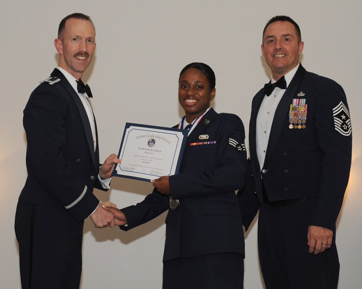 Senior Airman Krystal Liburd, 459th Logistics Readiness Squadron, Joint Base Andrews, Md., receives an Airman Leadership School graduation certificate from Col. Leland Bohannon, 2nd Bomb Wing vice commander, during the ALS Class 14-3 Graduation on Barksdale Air Force Base, La., March 27, 2014. (U.S. Air Force photo/Senior Airman Benjamin Gonsier)