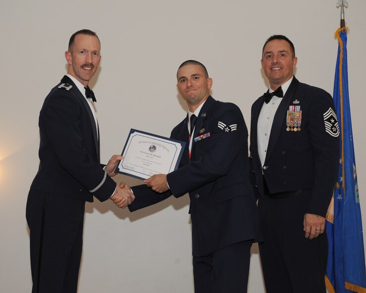 Senior Airman Travis Hendell, 911th Civil Engineer Squadron, Pittsburgh Air Reserve Station, Pa., receives an Airman Leadership School graduation certificate from Col. Leland Bohannon, 2nd Bomb Wing vice commander, during the ALS Class 14-3 Graduation on Barksdale Air Force Base, La., March 27, 2014. (U.S. Air Force photo/Senior Airman Benjamin Gonsier)