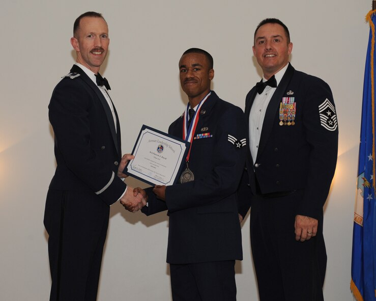 Senior Airman Patrick David, 927th Force Support Squadron, MacDill Air Force Base, Fla., receives an Airman Leadership School graduation certificate from Col. Leland Bohannon, 2nd Bomb Wing vice commander, during the ALS Class 14-3 Graduation on Barksdale AFB, La., March 27, 2014. (U.S. Air Force photo/Senior Airman Benjamin Gonsier)