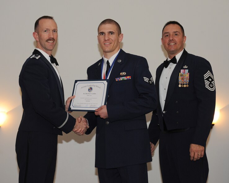 Senior Airman Michael Ardito, 2nd Maintenance Group, receives an Airman Leadership School graduation certificate from Col. Leland Bohannon, 2nd Bomb Wing vice commander, during the ALS Class 14-3 Graduation on Barksdale Air Force Base, La., March 27, 2014. (U.S. Air Force photo/Senior Airman Benjamin Gonsier)