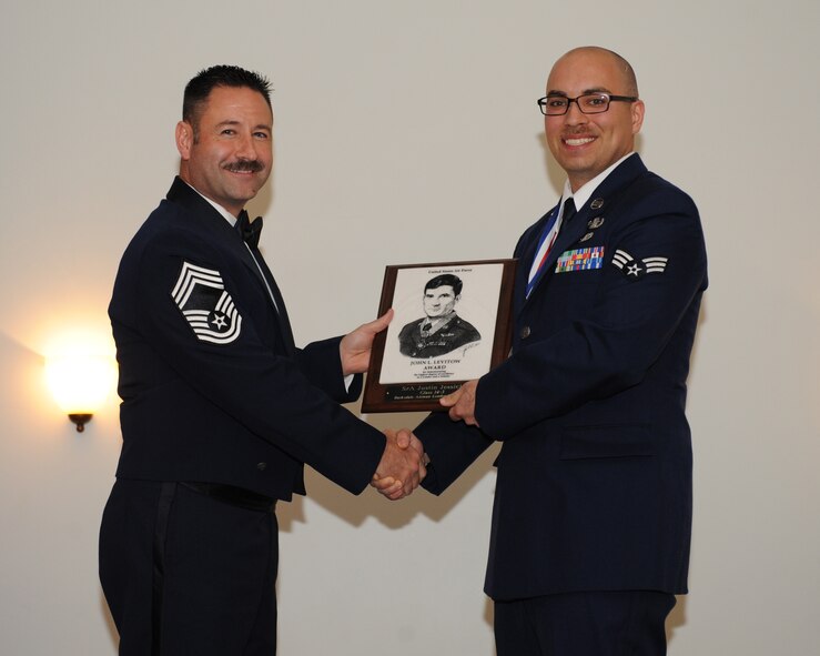 Senior Airman Justin Jessick, 2nd Civil Engineer Squadron, receives the John L. Levitow Award from Chief Master Sgt. Wayne Jones, Air Force Global Strike Command, during the Airman Leadership School Class 14-3 Graduation on Barksdale Air Force Base, La., March 27, 2014. (U.S. Air Force photo/Senior Airman Benjamin Gonsier)