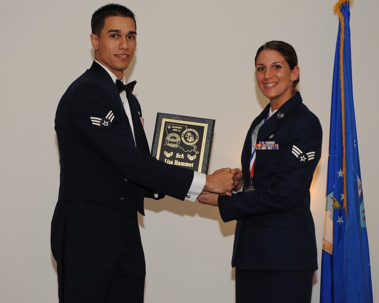 Senior Airman Lisa Hammett, 2nd Logistics Readiness Squadron, receives the Distinguished Graduate Award from Senior Airman Jorge Garcia-Gonzalez, 2nd Force Support Squadron, during the Airman Leadership School Class 14-3 Graduation on Barksdale Air Force Base, La., March 27, 2014. (U.S. Air Force photo/Senior Airman Benjamin Gonsier)