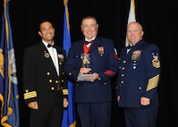 Representing the Coast Guard for award presentations during the Joint Base San Antonio Annual Awards Banquet March 29 are Commander Gene Anzano, left, and Master Chief Intelligence Specialist Alan Paul, right. Lt. Steven Welch, center, from the Coast Guard Cryptologic Unit received the Company Grade Officer of the Year Award. (U.S. Air Force photo by Melissa Peterson)