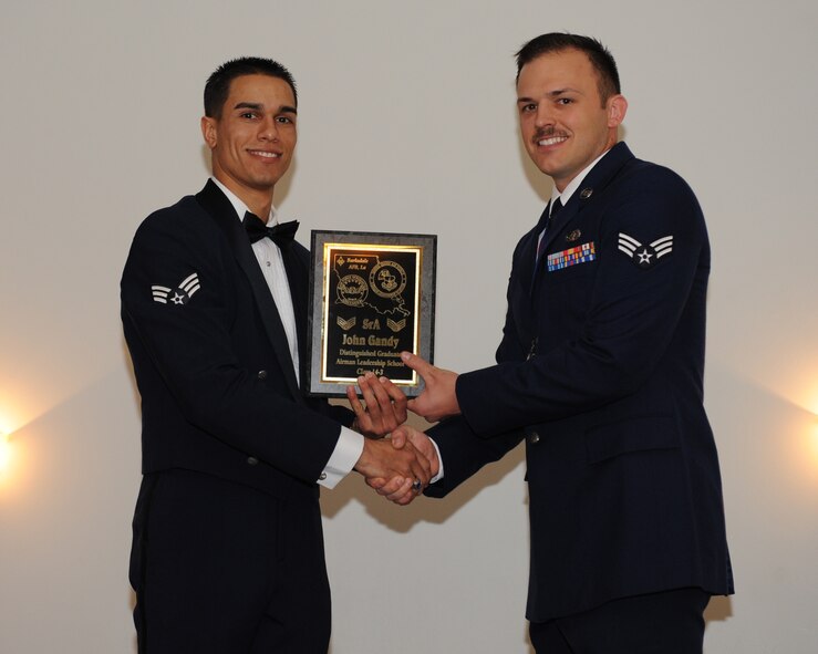 Senior Airman John Gandy, 2nd Communications Squadron, receives the Distinguished Graduate Award from Senior Airman Jorge Garcia-Gonzalez, 2nd Force Support Squadron, during the Airman Leadership School Class 14-3 Graduation on Barksdale Air Force Base, La., March 27, 2014. (U.S. Air Force photo/Senior Airman Benjamin Gonsier)