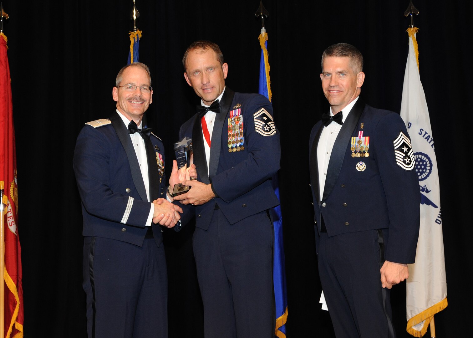 Representing the Air Force for award presentations during the Joint Base San Antonio Annual Awards Banquet March 29 are Brig. Gen. Bob Labrutta, left and Chief Master Sgt. Alex Perry, right. Senior Master Sgt. Jason Hodges, center, from the 37th Training Wing, received the First Sergeant of the Year Award. (U.S. Air Force photo by Melissa Peterson)