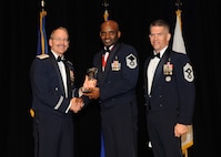 Representing the Air Force for award presentations during the Joint Base San Antonio Annual Awards Banquet March 29 are Brig. Gen. Bob Labrutta, left, and Chief Master Sgt. Alex Perry, right. Master Sgt. Lamond Barnes, center, from the 59th Medical Wing, received the Senior Enlisted Member of the Year Award. (U.S. Air Force photo by Melissa Peterson)