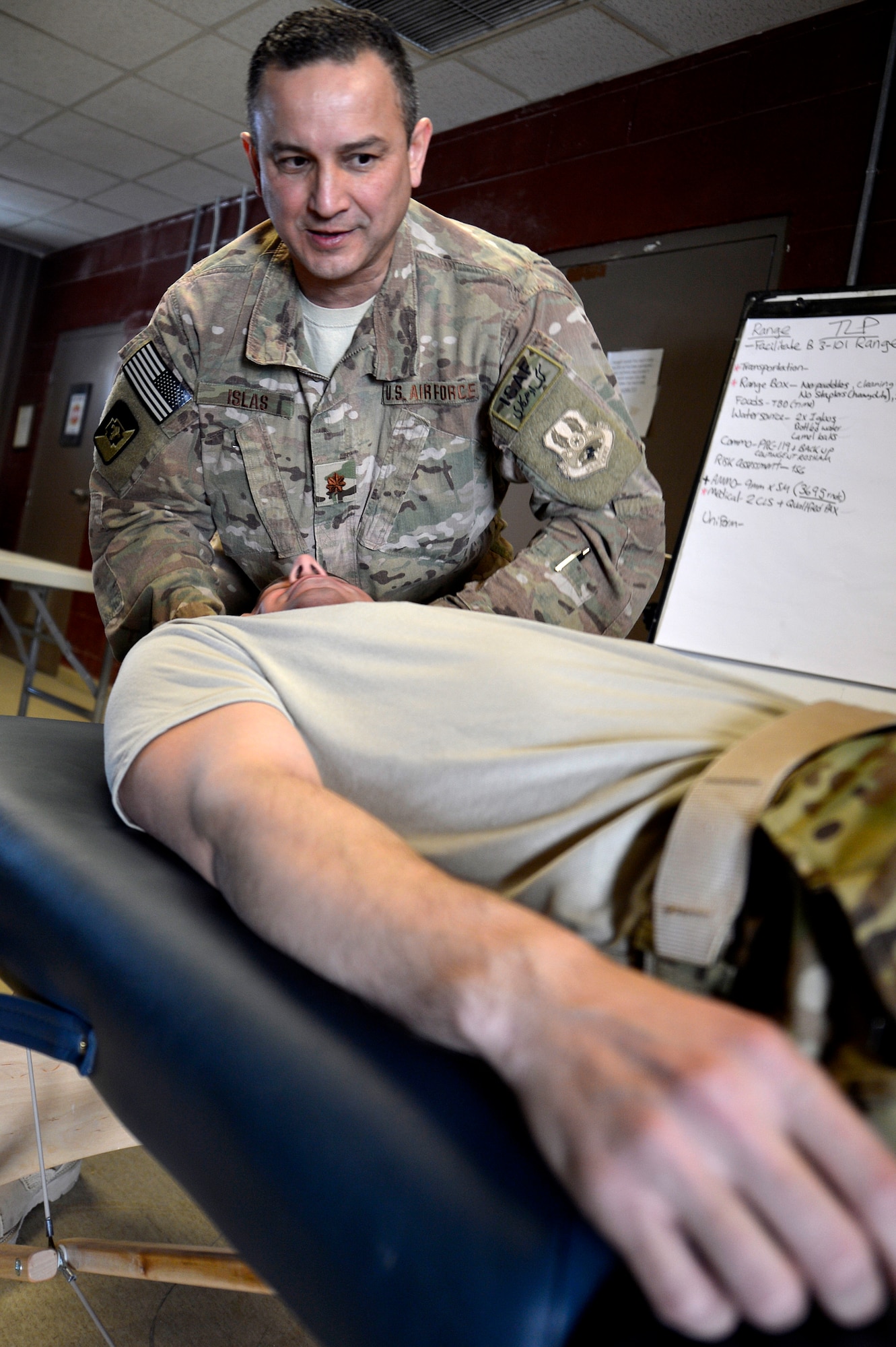 U.S. Air Force Maj. Felix Islas, 455th Expeditionary Medical Operations Squadron physical therapy element chief, performs a technique on a Service member’s neck at Bagram Airfield, Afghanistan, Jan. 30, 2014. Islas treats all Service members at Bagram, as well as coalition forces, Afghan nationals and Department of Defense civilians. Islas is a native of Port Lavaca, Texas, and deployed from the 359th Medical Group at Joint-Base San Antonio-Randolph, Texas. (U.S. Air Force photo by Senior Airman Kayla Newman/Released)