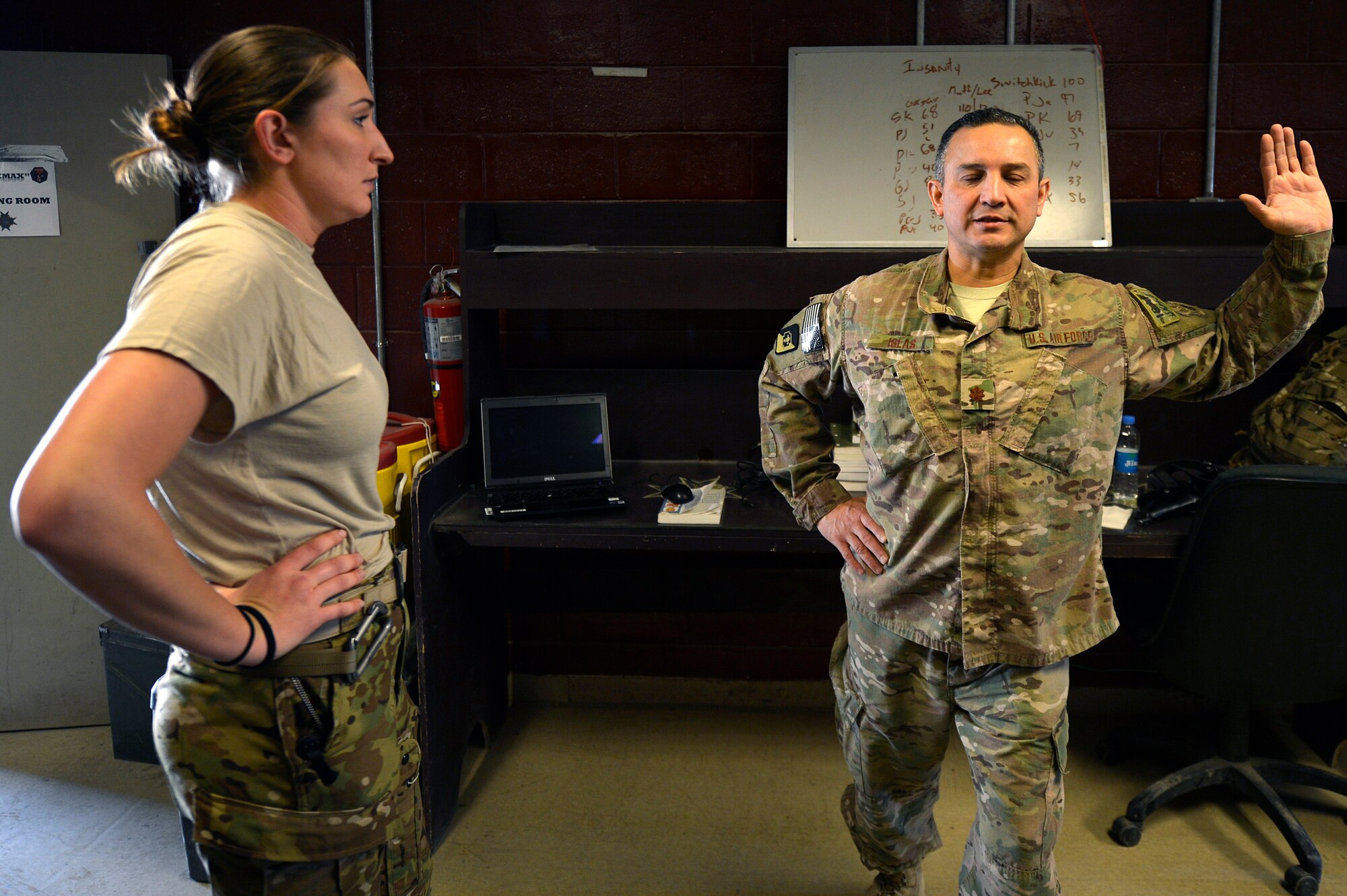 U.S. Air Force Maj. Felix Islas, 455th Expeditionary Medical Operations Squadron physical therapy element chief, demonstrates a proper stretching technique for a Service member at Bagram Airfield, Afghanistan, Jan. 30, 2014. Islas treats all Service members at Bagram, as well as coalition forces, Afghan nationals and Department of Defense civilians. Islas is a native of Port Lavaca, Texas, and deployed from the 359th Medical Group at Joint-Base San Antonio-Randolph, Texas. (U.S. Air Force photo by Senior Airman Kayla Newman/Released)