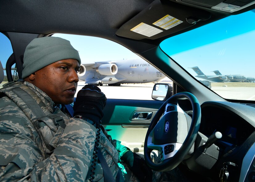Tech. Sgt. Laurance Isaac, 436th Security Forces Squadron bravo flight chief, conducts a radio check on the flight line March 24, 2014, at Dover Air Force Base Del. The 436th SFS conducts regular patrols of the flight line to ensure adequate security and safety. (U.S. Air Force photo/Airman 1st William Johnson)