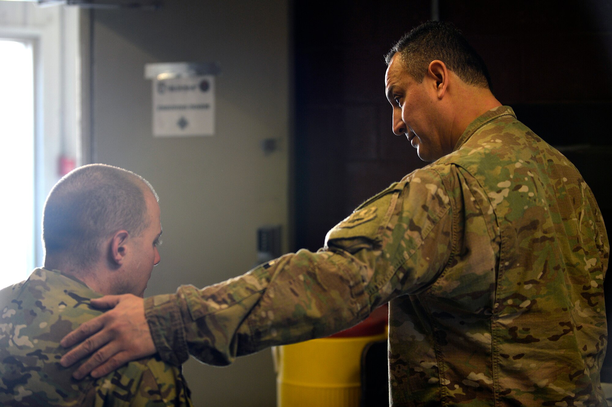 U.S. Air Force Maj. Felix Islas, 455th Expeditionary Medical Operations Squadron physical therapy element chief, consults with a patient after a treatment at Bagram Airfield, Afghanistan, Jan. 30, 2014. Islas is the only physical therapist at Bagram and treats patients with different types of musculoskeletal problems. Islas is a native of Port Lavaca, Texas, and deployed from the 359th Medical Group at Joint-Base San Antonio-Randolph, Texas. (U.S. Air Force photo by Senior Airman Kayla Newman/Released)