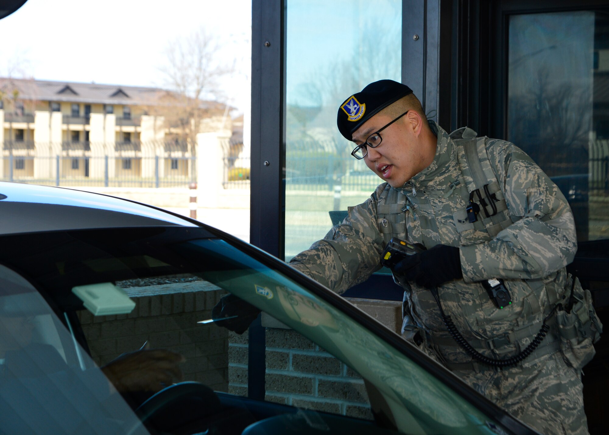 Airman 1st Class Peter Cheun, 436th Security Forces Squadron response force member, checks identification cards at the main gate March 24, 2014, at Dover Air Force Base, Del. The 436th SFS won the Air Mobility Command Outstanding Security Forces Unit award. (U.S. Air Force photo/Airman 1st Class William Johnson)