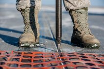 A reflective device is aligned to be used with a Trimble Total Station at Minot Air Force Base, N.D., March 19, 2014. The station is used to ensure that a snow fence is properly aligned so that it can act as a temporary runway marking on taxi-way Echo. This summer, Minot AFB in coordination with Sundt Construction and the United States Army Corps of Engineers will be performing a $32.8 million runway repair project to replace close to 9,000 feet of the center keel section. (U.S. Air Force photo/Senior Airman Stephanie Sauberan)