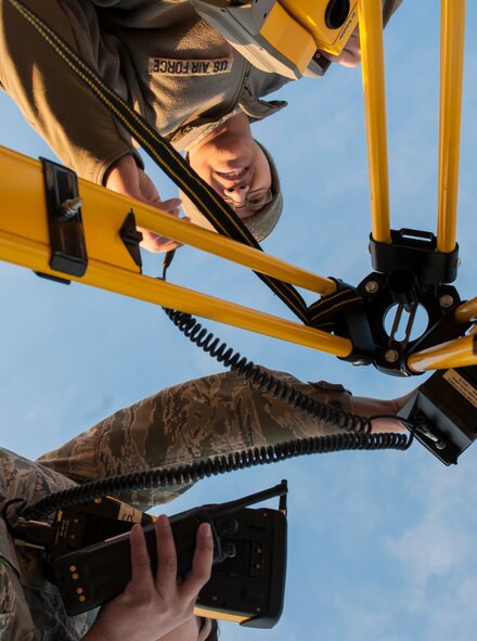 Airman 1st Class Trojan Dimagan, 5th Civil Engineer Squadron engineering apprentice adjusts a Trimble Total Station at Minot Air Force Base, N.D., March 19, 2014. The station will be used to check the alignment of a Precision Approach Path Indicator which will act as temporary runway lighting during construction on the flight line later this year. (U.S. Air Force photo/Senior Airman Stephanie Sauberan)