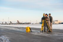 Airmen from the 5th Civil Engineer Squadron use a Trimble Total Station to check the alignment of temporary runway lighting at Minot Air Force Base, N.D., March 19, 2014. The station is used to ensure that a Precision Approach Path Indicator is properly aligned so that it can act as temporary runway lighting during construction on the flight line later this year. This summer, Minot AFB in coordination with Sundt Construction and the United States Army Corps of Engineers will be performing a $32.8 million runway repair project to replace close to 9,000 feet of the center keel section.  (U.S. Air Force photo/Senior Airman Stephanie Sauberan)