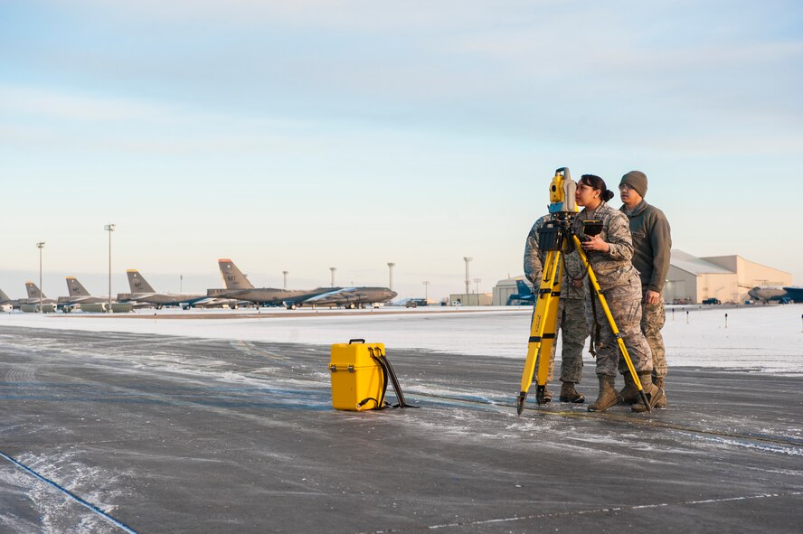 Airmen from the 5th Civil Engineer Squadron use a Trimble Total Station to check the alignment of temporary runway lighting at Minot Air Force Base, N.D., March 19, 2014. The station is used to ensure that a Precision Approach Path Indicator is properly aligned so that it can act as temporary runway lighting during construction on the flight line later this year. This summer, Minot AFB in coordination with Sundt Construction and the United States Army Corps of Engineers will be performing a $32.8 million runway repair project to replace close to 9,000 feet of the center keel section.  (U.S. Air Force photo/Senior Airman Stephanie Sauberan)