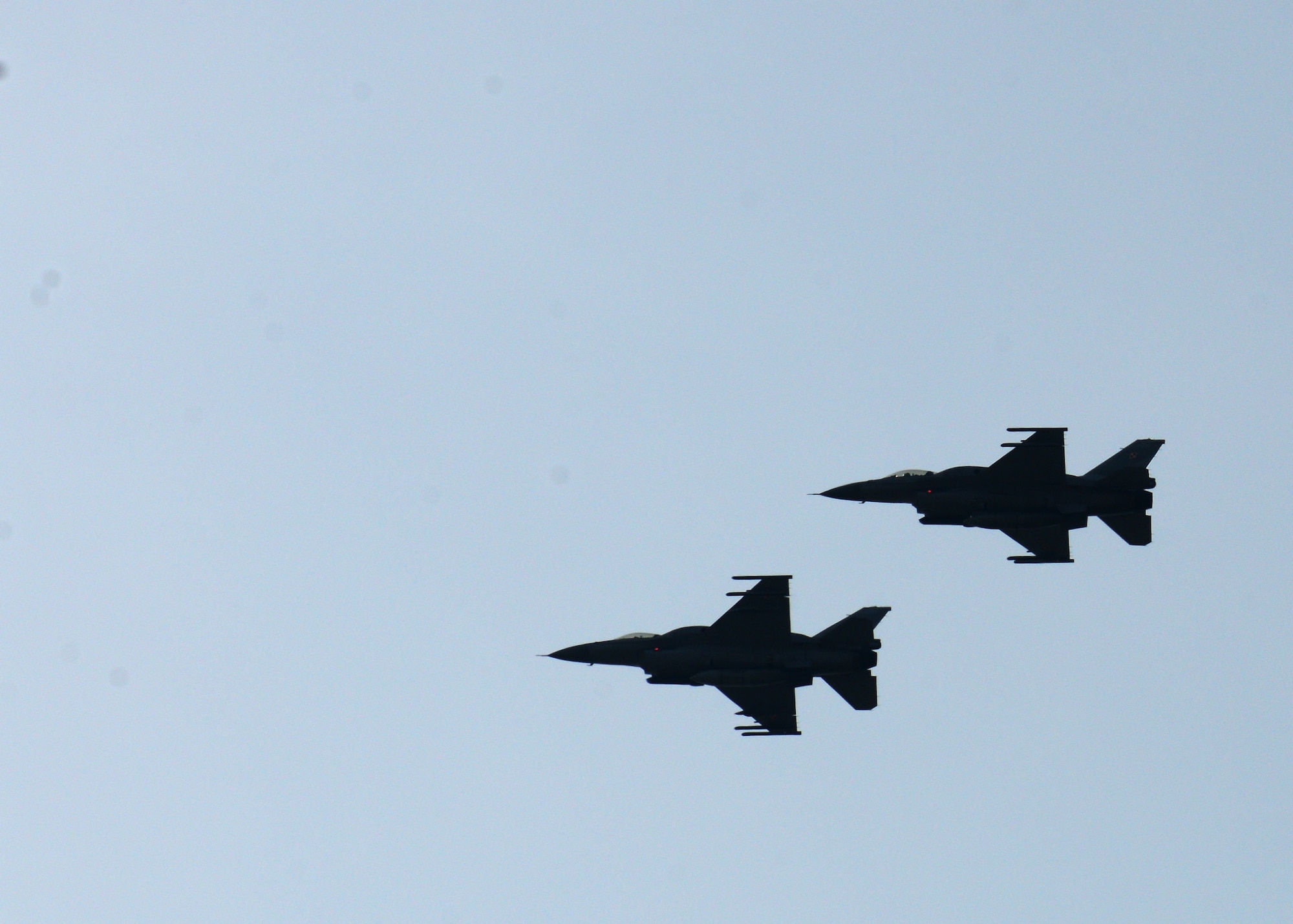 Two Polish air force F-16 Fighting Falcon fighter aircraft fly in formation during a training mission, April 1, 2014, over Łask Air Base, Poland. Poland continues to build its relationship with the U.S. as both nations' air forces train in a joint theater capacity for the first time since the arrival of 31st Fighter Wing aircraft and personnel from Aviano Air Base, Italy. (U.S. Air Force photo/Airman 1st Class Ryan Conroy/Released)