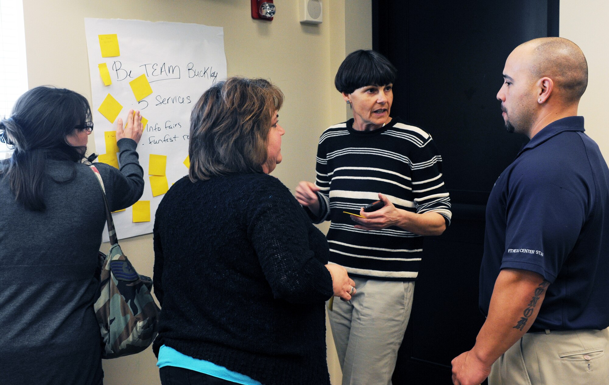 Attendees of the Caring for People forum discuss their votes for the most prominent issues March 28, 2014 at the chapel on Buckley AFB, Colo. The forum was a chance for Team Buckley members to address and share opinions on issues in the local community. (U.S. Air Force photo by Airman Emily E. Amyotte/Released)