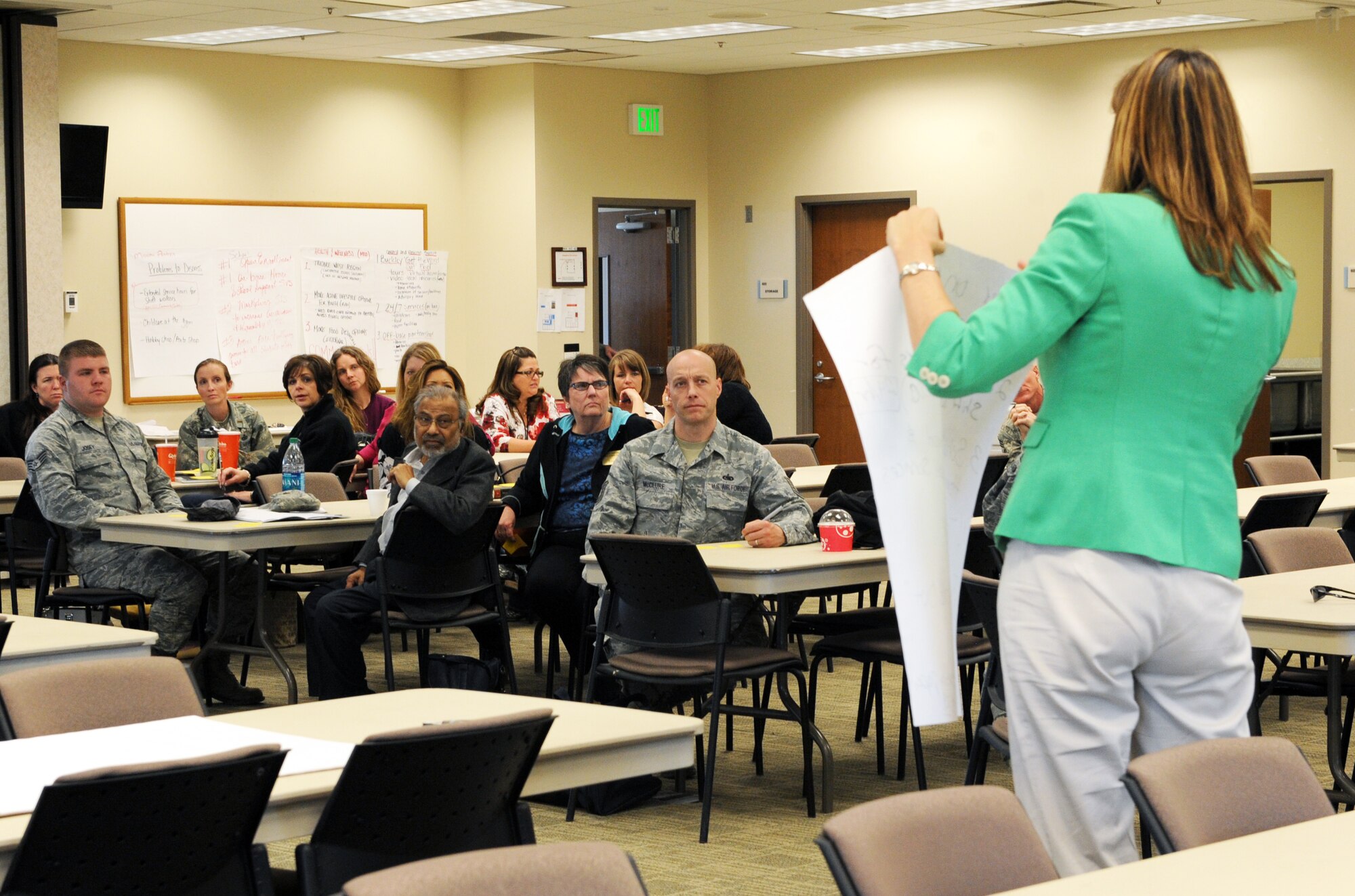 Christina Stump, 460th Space Wing community support coordinator and director of the Caring for People forum, displays the final list of issues to the attendees of the forum March 28, 2014 at the chapel on Buckley AFB, Colo. The forum was a chance for Team Buckley members to address and share opinions on issues in the local community. (U.S. Air Force photo by Airman Emily E. Amyotte/Released)