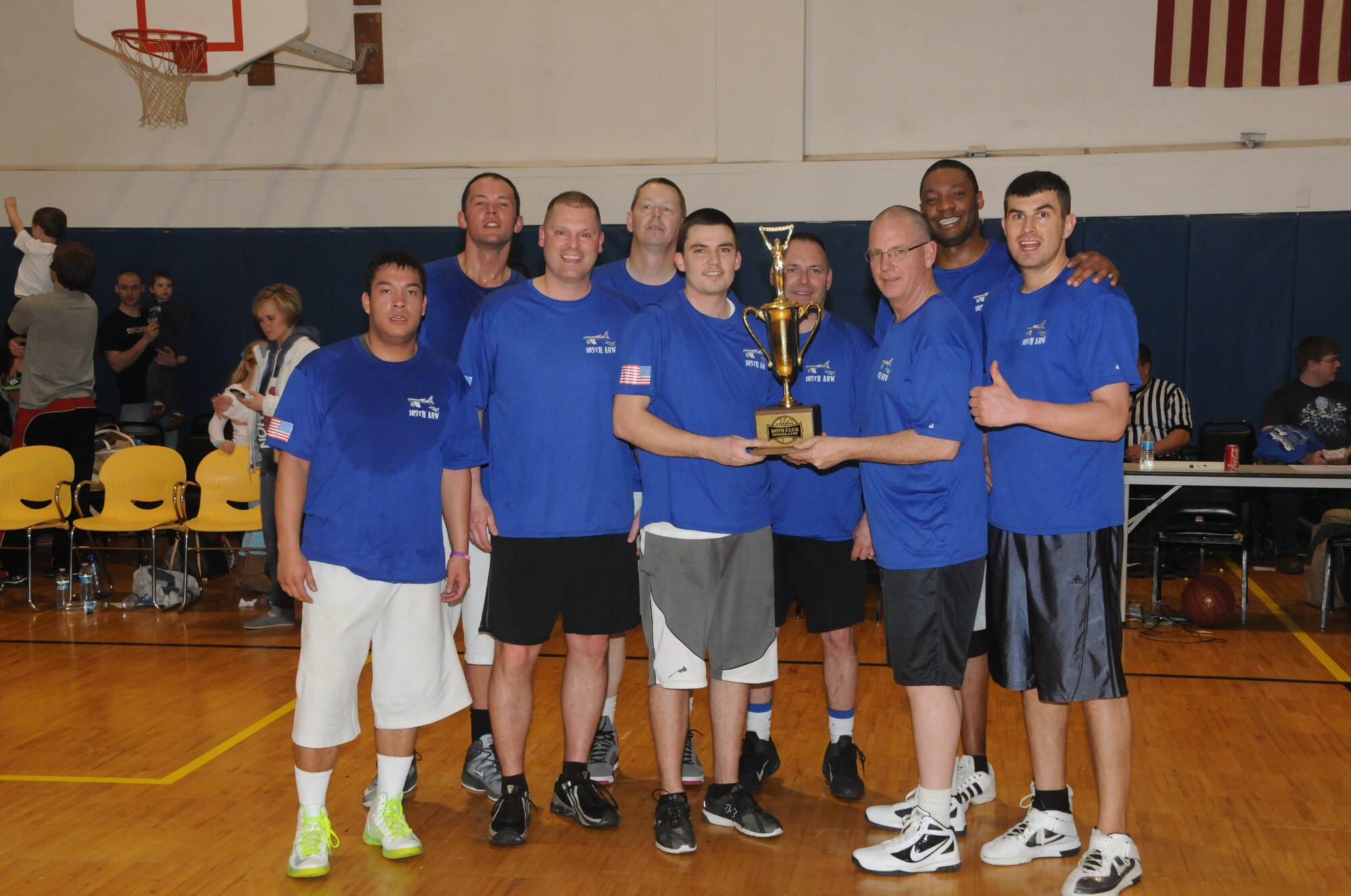 Members of the Air National Guard's 185th Air Refueling Wing were presented with a trophy after beating the Army National Guard's 113th Cavalry 68 to 59 in basketball during the Inaugural Boys Club Heroes Game on March 28th, 2014 in Sioux City, Ia. (U.S. Air National Guard photo by 1st Lt. Jeremy J. McClure/Released)