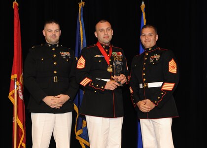 Representing the Marines for award presentations during the Joint Base San Antonio Annual Awards Banquet March 29 are Maj. Martin Gale, left, and Master Sgt. David Villareal, right. Gunnery Sgt. Antonio Lopez, center, from Marine Detachment JBSA-Lackland, received the Senior Enlisted Member of the Year Award. (U.S. Air Force photo by Melissa Peterson)