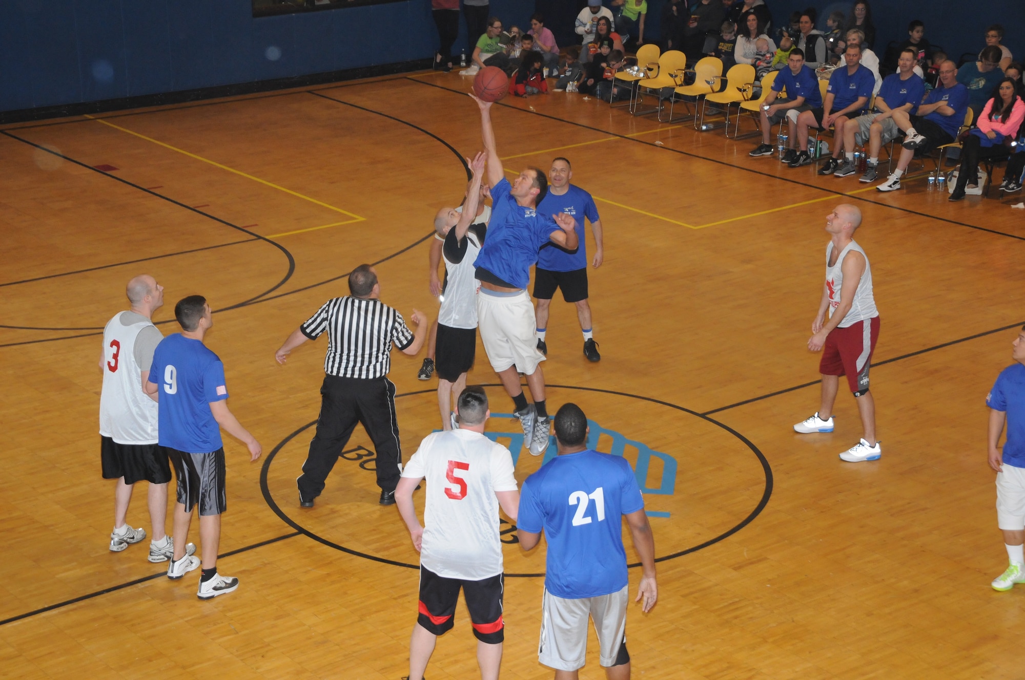 Air National Guard Tech. Sgt. Chase Gill leaps for the ball during the tip off of the Inaugural Boys Club Heroes Game where members of the 185th Air Refueling Wing took on members of the Army National Guard's 113th Cavalry Regiment on March 28, 2014 in Sioux City, IA. (U.S. Air National Guard photo by 1st Lt. Jeremy J. McClure/Released)