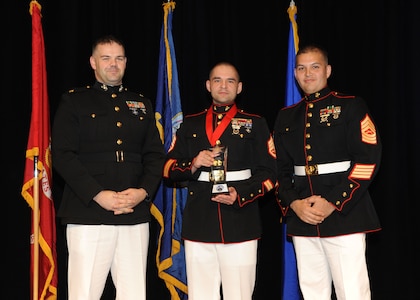 Representing the Marines for award presentations during the Joint Base San Antonio Annual Awards Banquet March 29 are Maj. Martin Gale, left, and Master Sgt. David Villareal, right. Staff Sgt. Michael R. Armendariz, center, from the 4th Reconnaissance Battalion, received the NCO of the Year Award. (U.S. Air Force photo by Melissa Peterson)