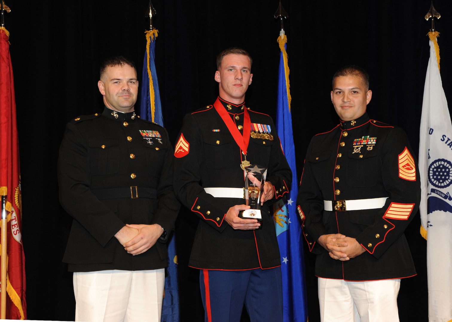 Representing the Marines for award presentations during the Joint Base San Antonio Annual Awards Banquet March 29 are Maj. Martin Gale, left, and Master Sgt. David Villareal, right.  Cpl. Taylor Decicco, center, from Marine Detachment JBSA-Lackland, received the Junior Enlisted Member of the Year Award. (U.S. Air Force photo by Melissa Peterson)
