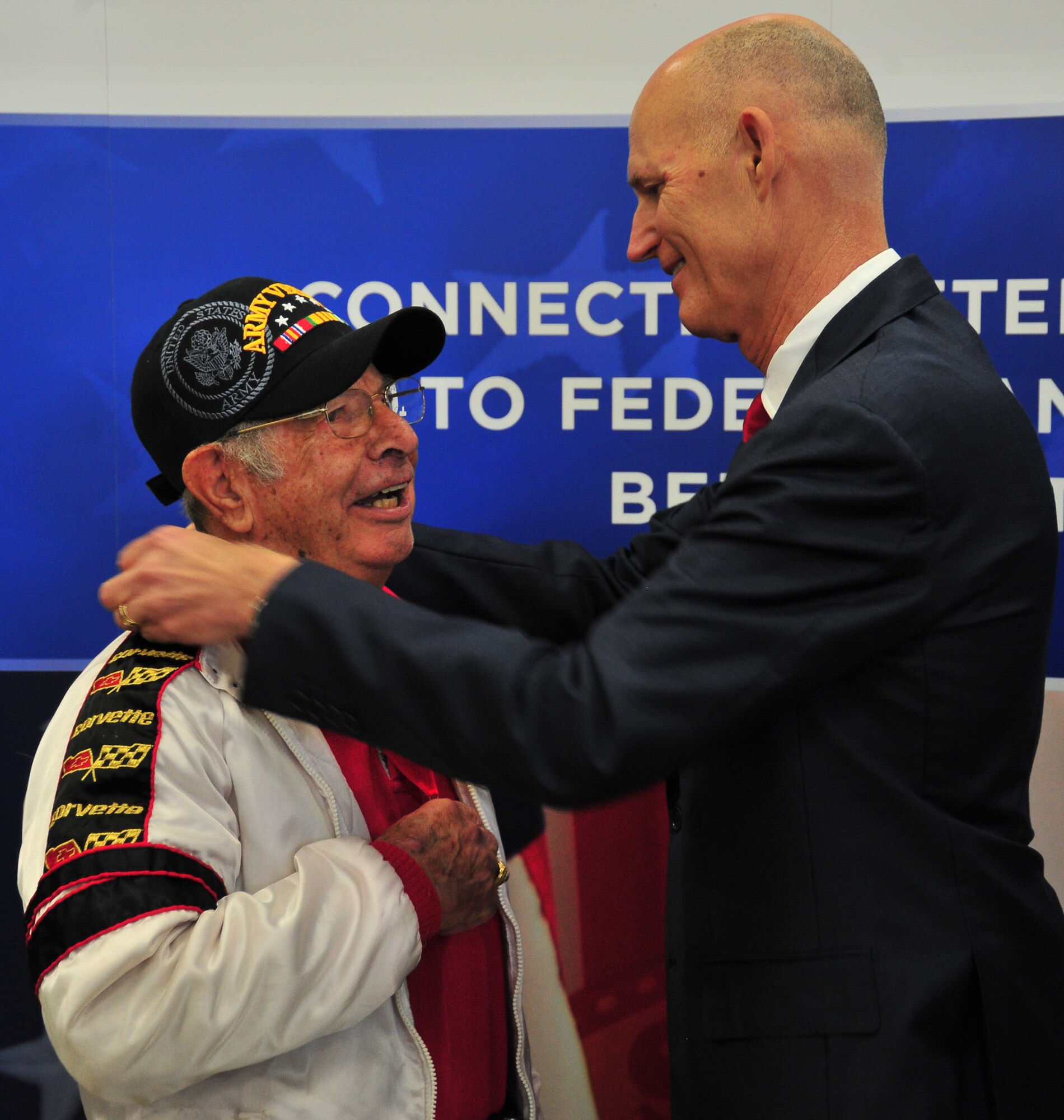 Rich Scott, Florida Governor, presents the Governor’s Veterans Service Award to a veteran who served during World War II March 31 at the National Guard Armory in Panama City. The bill expands education and career development opportunities for military service members, veterans and their families. (U.S. Air Force photo by Airman 1st Class Sergio A. Gamboa)