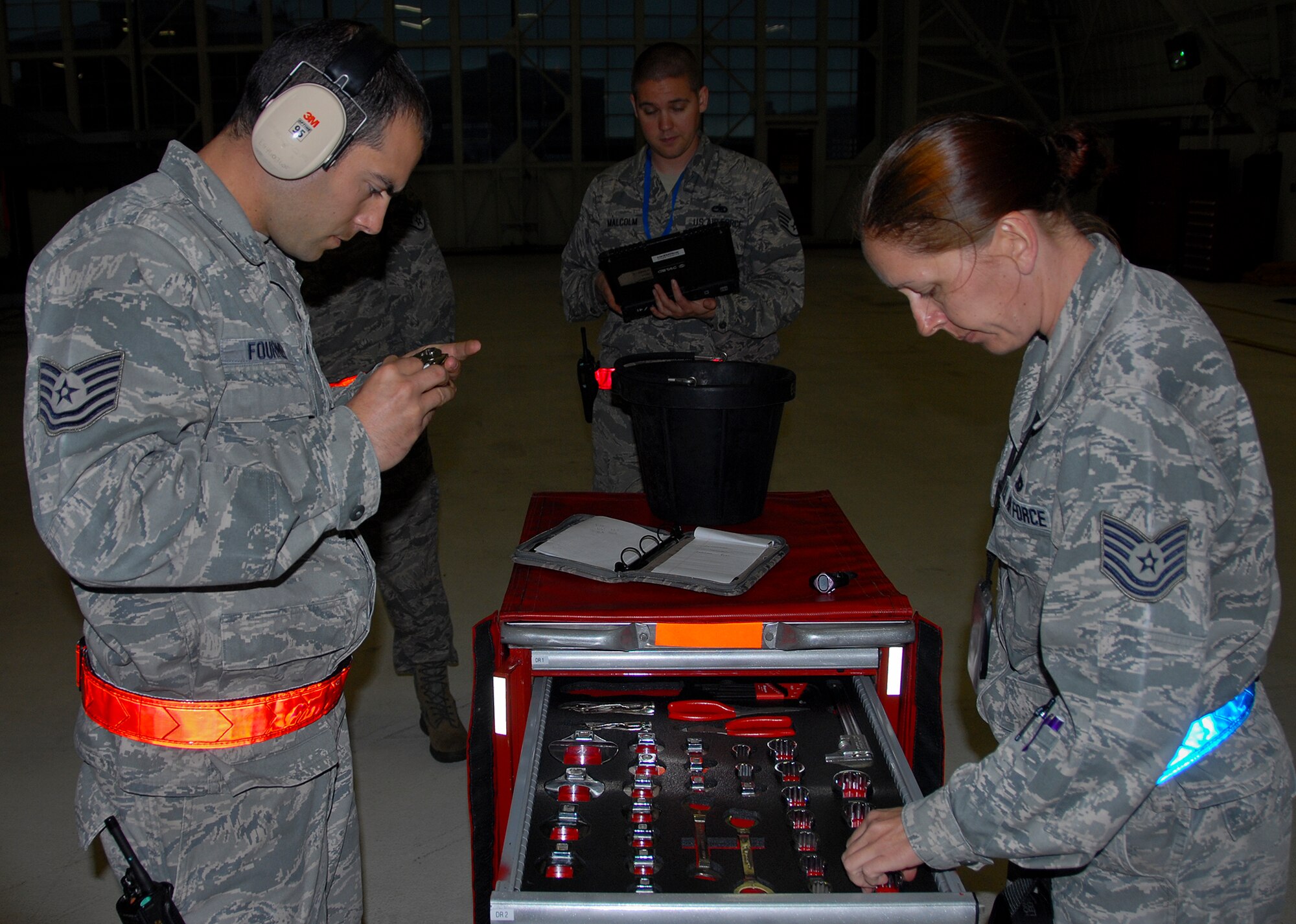 From left, Tech. Sgt. Joesph Fournier, Staff Sgt. Colin Malcolm and Tech. Sgt. Jennie Gorrell, of the 96th Maintenance Group, perform the dedicated crew chief composite tool kit inspection, during the quarterly weapons loadcrew competition March 28 at Eglin Air Force Base, Fla.  (U.S. Air Force photo/Kevin Gaddie)