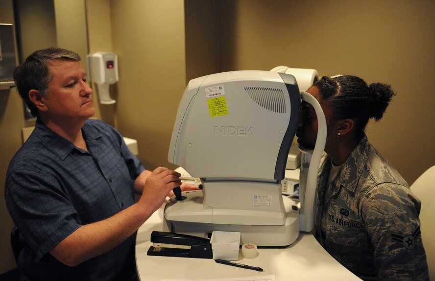 Michael Hoskins, 2nd Aerospace Medicine Squadron paraoptometric technician, positions a patient's eye for a glaucoma test on Barksdale Air Force Base, La., March 26, 2014. To test for glaucoma, optometry technicians use a tonometer, which shoots a puff of air into the patient's eyes. The air is used to measure a patient's eye pressure. Glaucoma is the leading cause of blindness in America, which is why it is essential to catch it early. (U.S. Air Force photo/Senior Airman Benjamin Gonsier)