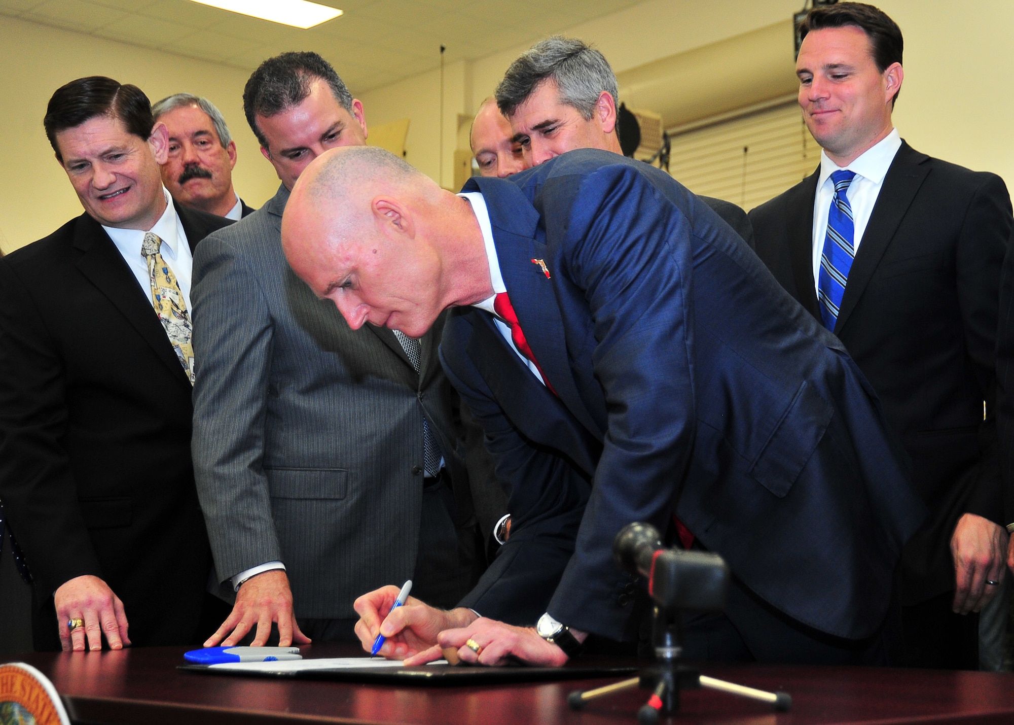 Rich Scott, Governor of Florida, signs The Florida GI Bill March 31 at the National Guard Armory in Panama City. The bill expands education and career development opportunities for military service members, veterans and their families. (U.S. Air Force photo by Airman 1st Class Sergio A. Gamboa)