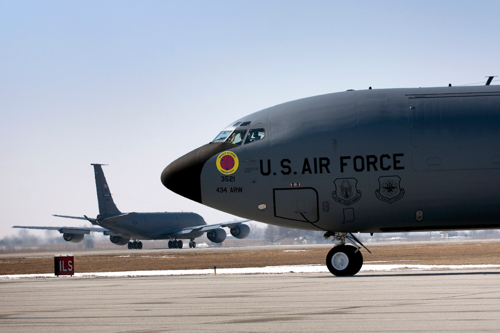 The Spirit of Peru, one of the 434th Air Refueling Wing's 16 KC-135R Stratotankers, waits its turn as another KC-135R takes off from Grissom Air Reserve Base, Ind., March 9, 2014. During the 434th ARW's March unit training assembly, the unit held a strategic warfare exercise, executing various response, mobility, and command and control procedures in response to a simulated global threat, which culminated in 10 Stratotankers taking off in two five-ship formations. (U.S. Air Force photo/Tech. Sgt. Mark R. W. Orders-Woempner)
