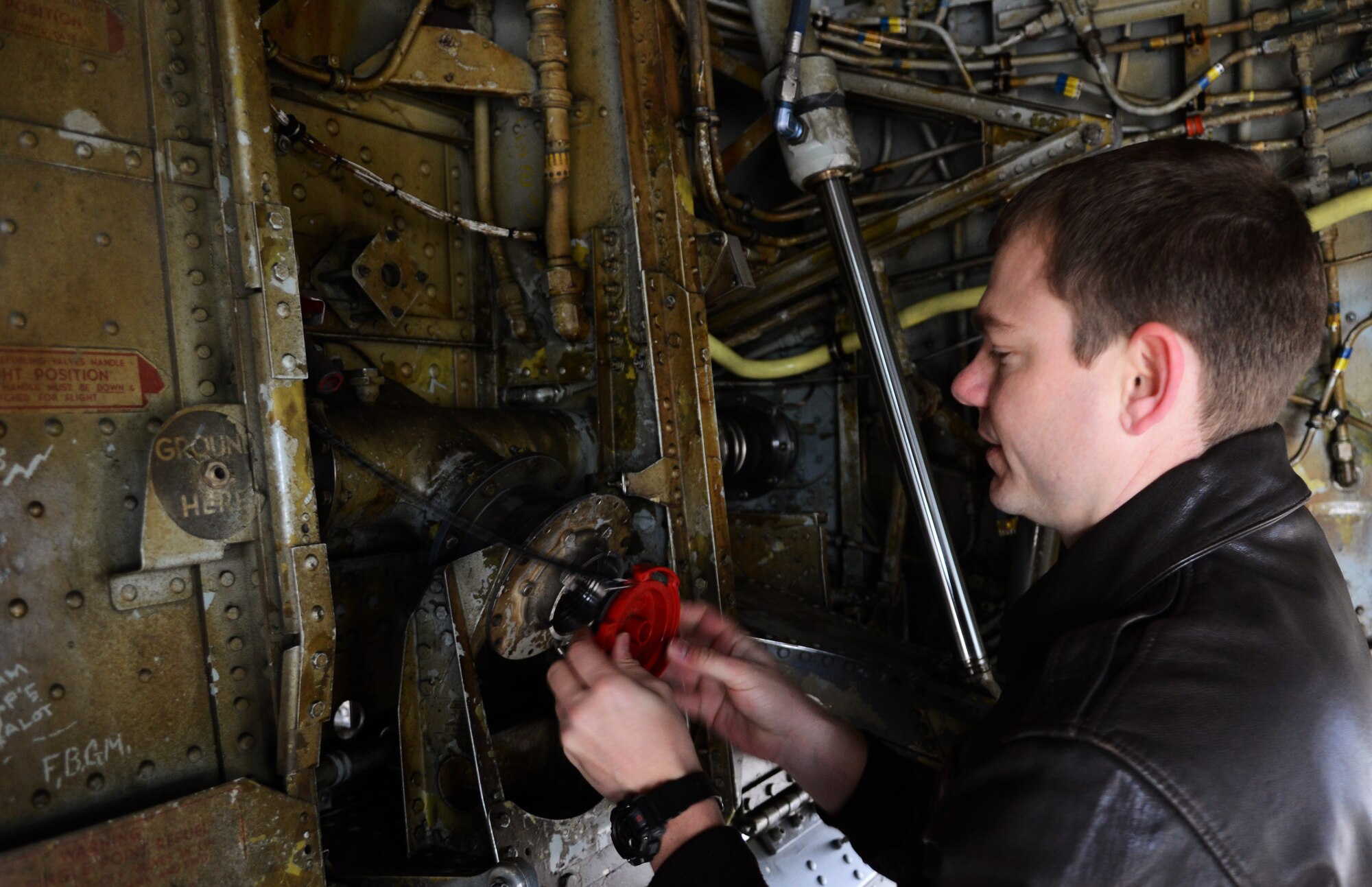 U.S. Air Force Capt. Phillip Stewart, 351st Air Refueling Squadron KC-135 Stratotanker pilot from Naples, Fla., performs a pre-flight check on the undercarriage of a KC-135 March 21, 2014, on RAF Mildenhall, England. Pilots perform checks before, during and after a flight to ensure that everything is in good working order at all times. (U.S. Air Force photo by Airman 1st Class Dillon Johnston/Released)