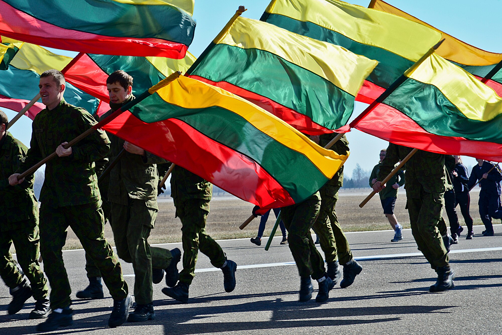 Members from the Lithuanian air force run during ‘Runway Run 2014,’ in celebration of the 10-year anniversary of Lithuania joining NATO and the Baltic Air Policing mission at Šiauliai Air Base, Lithuania, March 28, 2014. For the past 10 years, air forces from across NATO have shared the responsibility of patrolling the skies over Estonia, Latvia and Lithuania contributing to a safe and stable future. (U.S. Air Force photo by Airman 1st Class Dana J. Butler/Released)