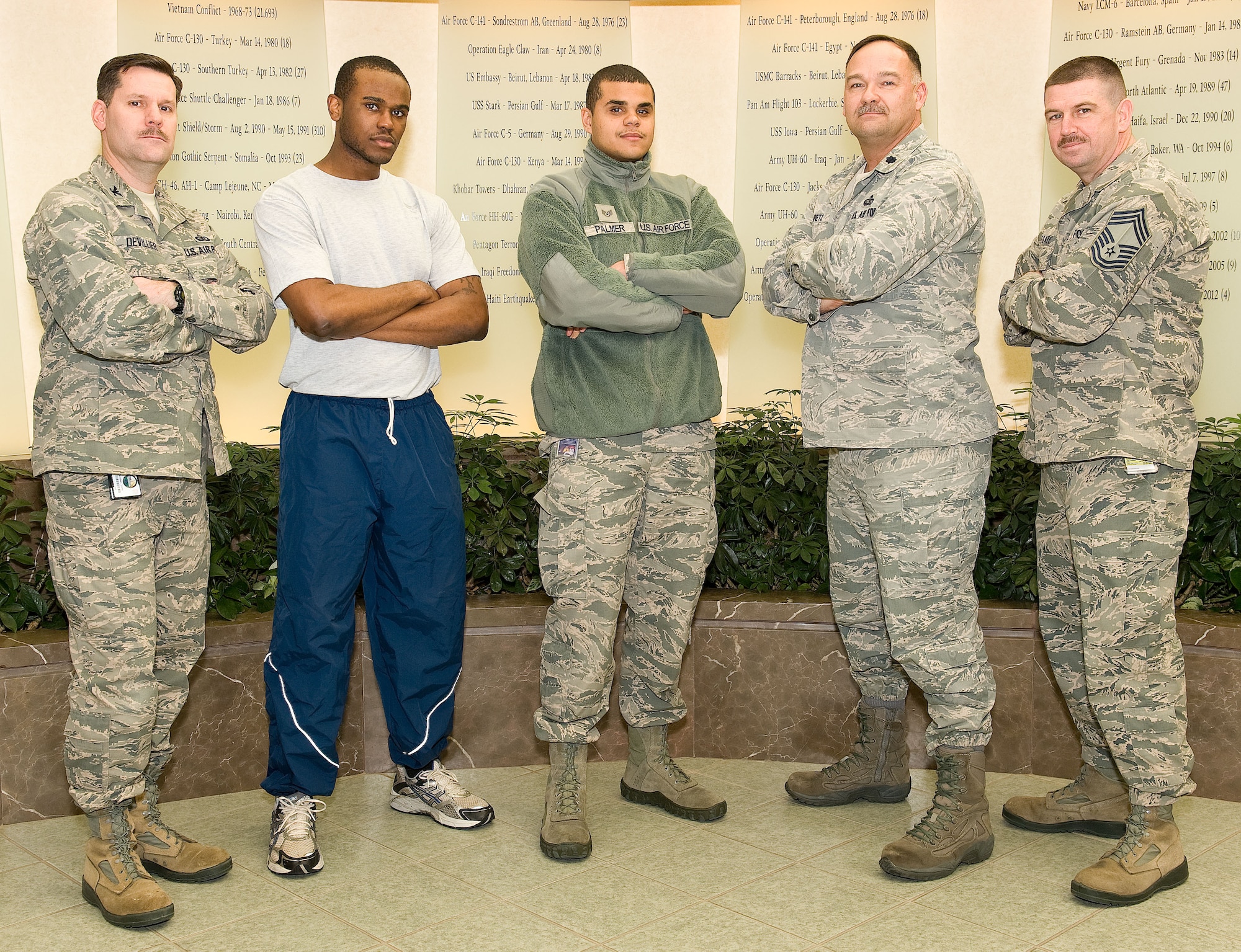 Col. John Devillier, Air Force Mortuary Affairs Operations commander, Senior Airman Marvin Young, departures specialist, Staff Sgt. Justin Palmer, Client Systems technician, Lt. Col. David Kretz, AFMAO deputy commander, and Chief Master Sgt. Sean Applegate, AFMAO chief enlisted manager, sport mustaches they grew for Mustache March as they pose in the atrium of the Charles C. Carson Center for Mortuary Affairs, Dover Air Force Base, Del., March 25, 2014. The mustaches were part of a challenge from Chief of Staff of the Air Force Gen. Mark Welsh, who issued the challenge to the entire Air Force. (U.S.  Air Force photo/Roland Balik)