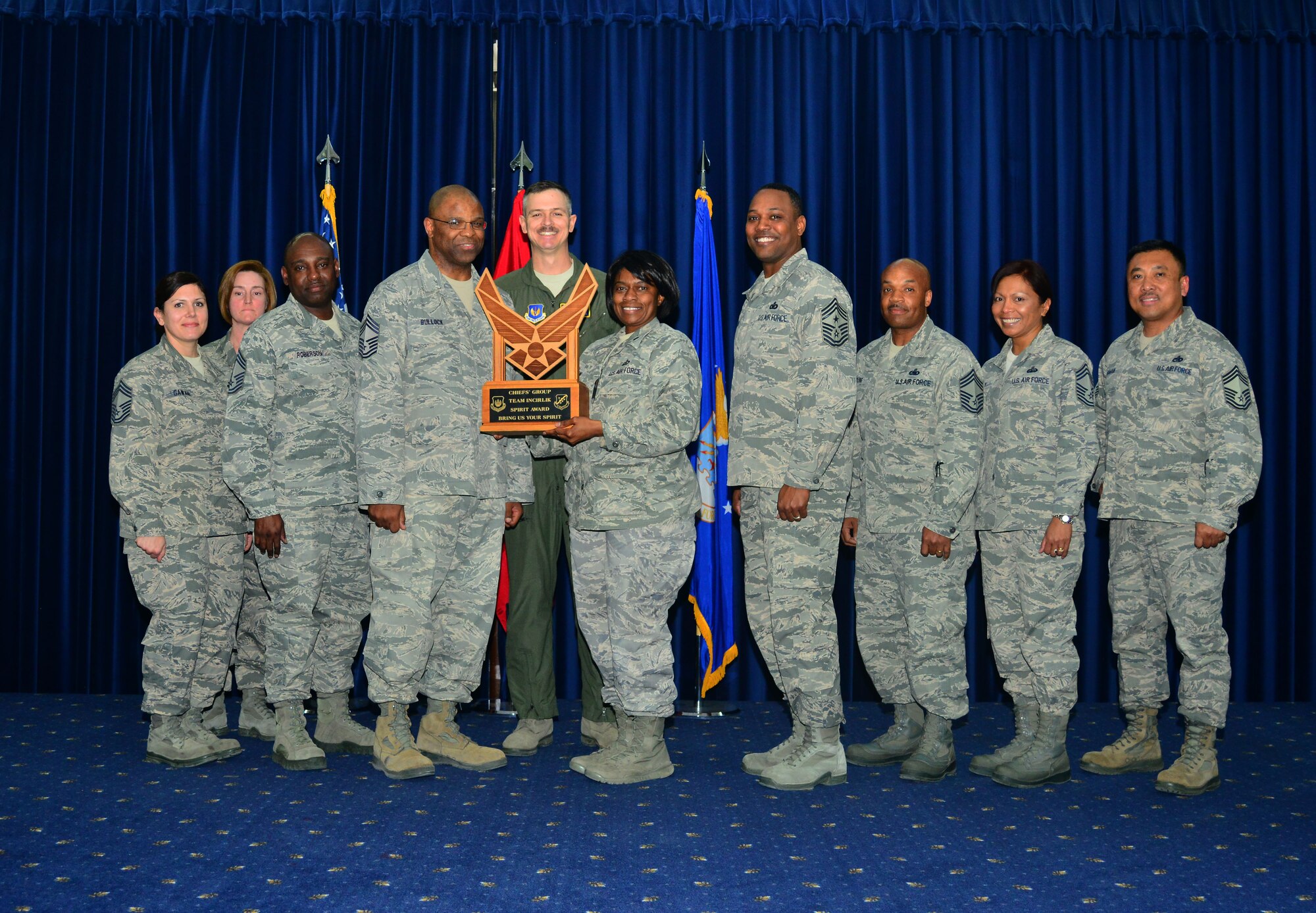 Lt. Col. Bernadette Bowman, 39th Force Support Squadron commander, center, accepts the Chief's Spirit Award on behalf of the 39th FSS during the promotion ceremony March 31, 2014, Incirlik Air Base, Turkey. The award is presented to the squadron that displays the most squadron "spirit" during the ceremony. (U.S. Air Force photo by Staff Sgt. Eric Summers Jr./Release)