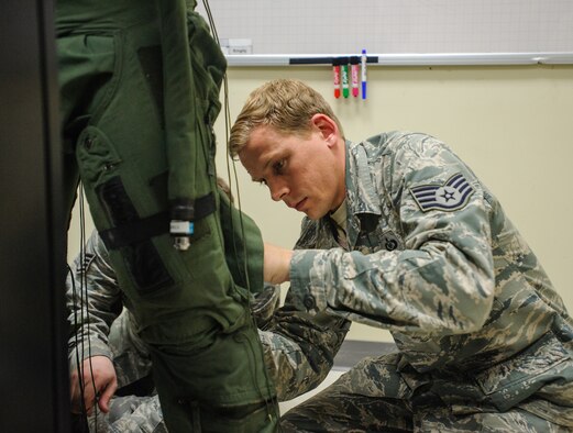 Staff Sgt. Jeffrey Morris, 8th Operations Support Squadron aircrew flight equipment specialist, tightens U.S. Army Command Sgt. Maj. John Troxell’s, United States Forces Korea command sergeant major, G-suit in preparation for a familiarization flight at Kunsan Air Base, Republic of Korea, Mar. 27, 2014. Troxell visited with Kunsan’s Airmen and saw how the Wolf Pack stays prepared and ready to fight tonight both on the ground and in the air. (U.S. Air Force photo by Senior Airman Armando A. Schwier-Morales/Released)
