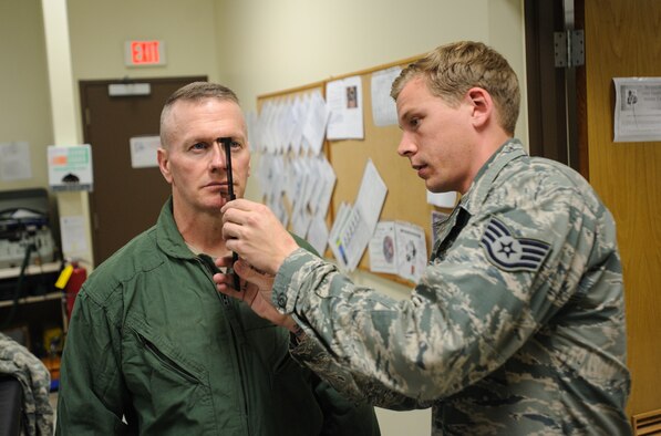 U.S. Army Command Sgt. Maj. John Troxell, United States Forces Korea command sergeant major, is measured by Staff Sgt. Jeffrey Morris, 8th Operations Support Squadron aircrew flight equipment specialist, for his mask size during a flight suit fitting at Kunsan Air Base, Republic of Korea, Mar. 27, 2014. Troxell visited with Kunsan’s Airmen and saw how the Wolf Pack stays prepared and ready to fight tonight both on the ground and in the air. (U.S. Air Force photo by Senior Airman Armando A. Schwier-Morales/Released)