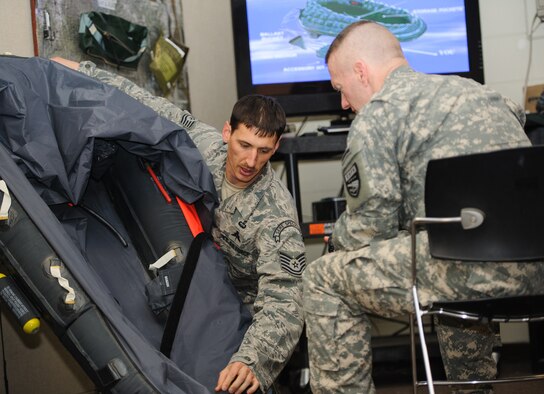 Tech. Sgt. Kurtis Douge, 8th Operations Support Squadron Survival, Evasion, Resistance and Escape specialist, trains U.S. Army Command Sgt. Maj. John Troxell, United States Forces Korea command sergeant major, on techniques he would use to survive an ejection over water at Kunsan Air Base, Republic of Korea, Mar. 27, 2014. Troxell visited with Kunsan’s Airmen and saw how the Wolf Pack stays prepared and ready to fight tonight both on the ground and in the air. (U.S. Air Force photo by Senior Airman Armando A. Schwier-Morales/Released)