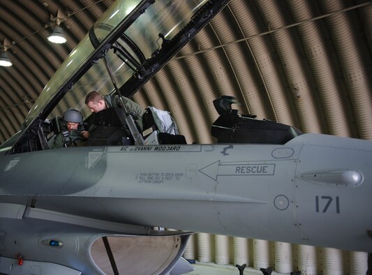 Capt. Joshua Bibb, 35th Fighter Squadron pilot, ensures U.S. Army Command Sgt. Maj. John Troxell, United States Forces Korea command sergeant major, is ready for his familiarization flight at Kunsan Air Base, Republic of Korea, Mar. 28, 2014. Troxell visited with Kunsan’s Airmen and saw how the Wolf Pack stays prepared and ready to fight tonight both on the ground and in the air. (U.S. Air Force photo by Senior Airman Armando A. Schwier-Morales/Released)
