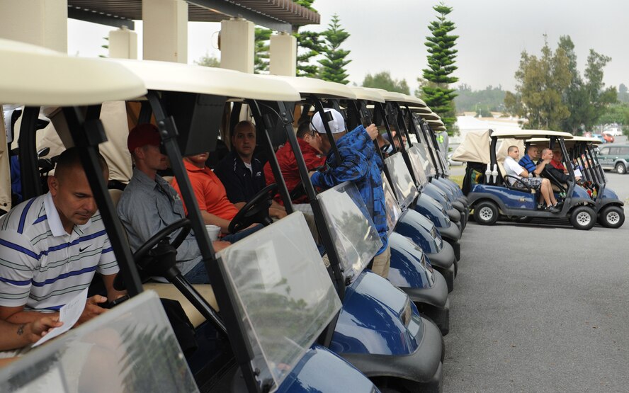 The participants for the 2014 Sexaul Assault Prevention and Response Golf Tournament line up to head to their starting hole at the Banyan Tree Golf Course on Kadena Air Base, Japan, March 28, 2014. This golf tournament is one of many events the SAPR team has organized for Sexual Assualt Awareness Month this year. (U.S. Air Force photo by Airman 1st Class Zackary Henry)