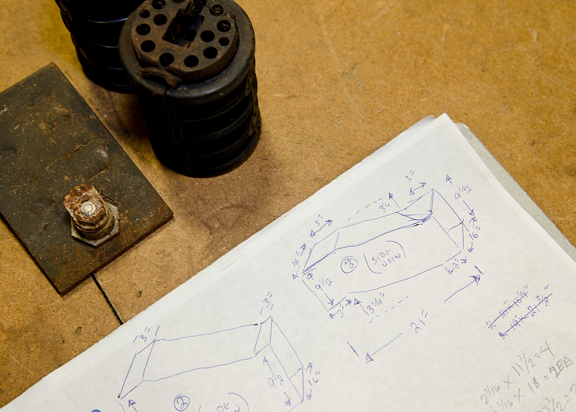 The rough sketch for a replacement duct in building 26006 is placed on a table to be used as a reference March 25, 2014, on Andersen Air Force Base, Guam. Prior to installation, job schematics are first sketched, verified and then cut into the appropriate pattern out of sheet metal. (U.S. Air Force photo by Senior Airman Katrina M. Brisbin/Released)