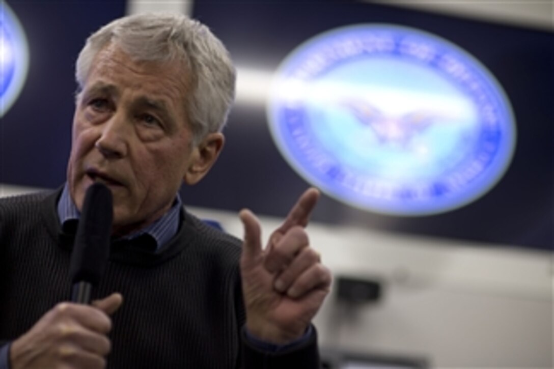 Defense Secretary Chuck Hagel briefs the traveling press on board a military aircraft en route to Hawaii, April 1, 2014, where he will host the first U.S.-ASEAN forum. Hagel will meet with ministers of the Association of Southeast Asian Nation, to help develop defense relationships in the region. 