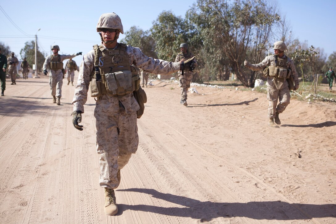 U.S. service members and members of the Royal Moroccan Armed Forces conduct non-lethal weapons training during Exercise African Lion 2014 on the Tifmit Royal Moroccan Armed Forces Base in Morocco, Mar. 27, 2014. African Lion is conducted as a combined-joint execrise between the Kingdom of Morocco and the U.S. Forces to strengthen relationships and military operability in the region. (U.S. Marine Corps photo by Cpl. Alexanria Blanche, 2D MARDIV COMCAM/Not Released)