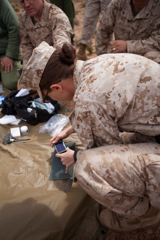 U.S. Marine Corps Lance Cpl. Chelsie A. Durfee, military policeman, 2nd Law Enforcement Battalion, 2nd Marine Expeditionary Briage, II Marine Expeditionary Force takes a picture of a finger print during a tactical site exploitation class as part of execrise African Lion 2014 on Tifnit Royal Moroccan Armed Forces Base in Agadir, Morocco, Mar. 29, 2014. African Lion is conducted as a combined joint exercise between the Kingdom of Morocco and the U.S. Forces to strengthen relationships and military operability in the region. (U.S. Marine Corps Photo by Cpl. Alexandria Blanche, 2D MARDIV COMCAM/Released)
