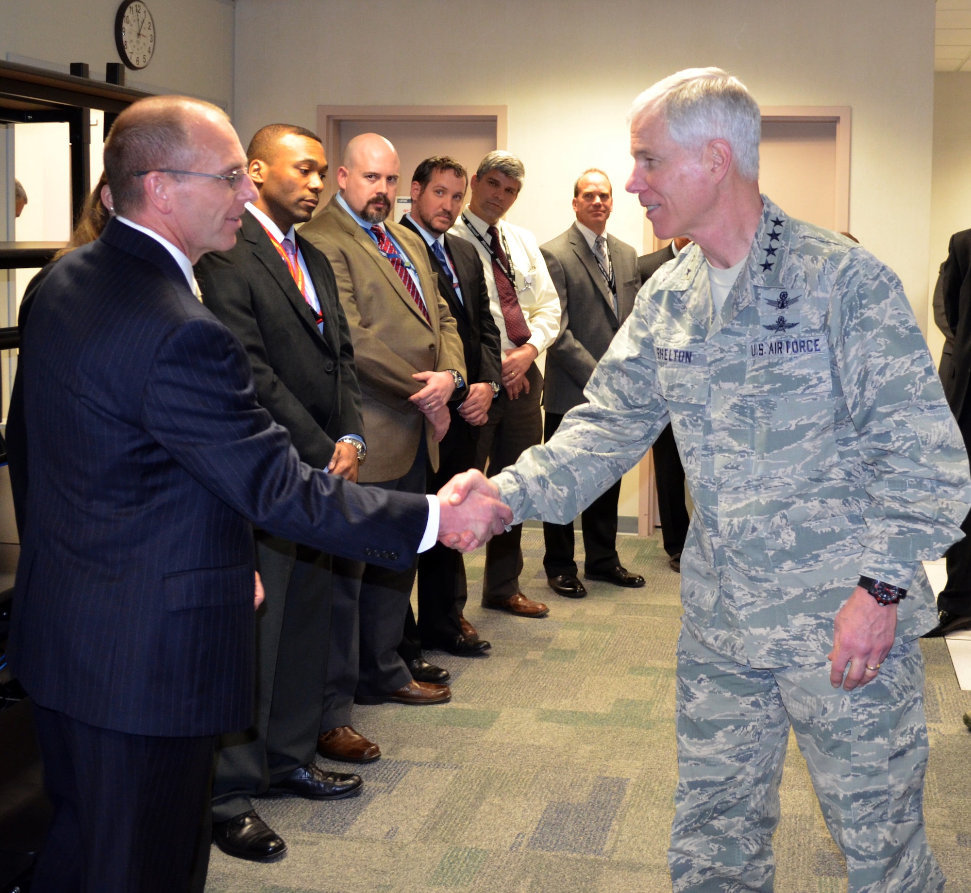 General William L. Shelton meets members of the Air Force Network Integration Center AFNET Migration project management team March 31, 2014, during his visit at Scott Air Force Base, Ill. During his visit, Shelton met the people who were integral to migrating user accounts onto the AFNET. Shelton is the Air Force Space Command commander. (U.S. Air Force Photo/Shelly Petruska)