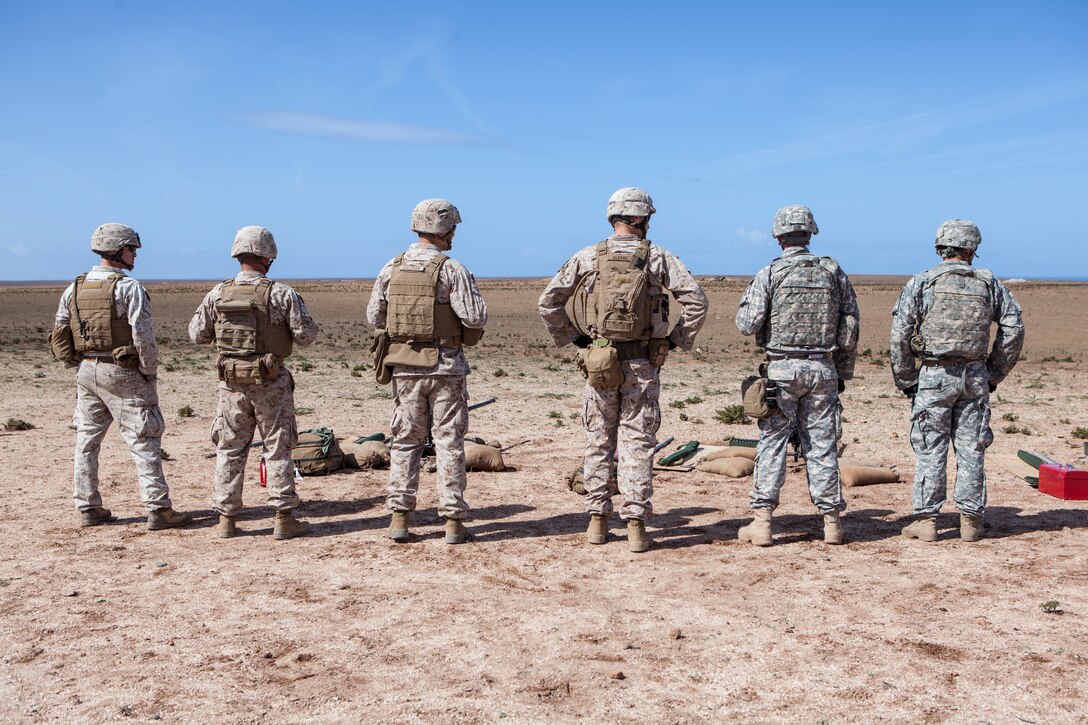 U.S. Marines with 2nd Law Enforcement Battalion, 2nd Marine Expeditionary Brigade, II Marine Expeditionary Force and soliders with 230th Military Police Company, 95th Military Police Battalion, 18th Military Police Brigade wait to begin a live fire training exercise during exercise African Lion 2014 on Tifnit Royal Moroccan Armed Forces Base in Agadir, Morocco, Mar. 29, 2014. African Lion is conducted as a combined joint exercise between, the Kingdom of Morocco and the U.S. Forces to stregthen relationships and military operability in the region. (U.S. Marine Corps photo by Cpl. Alexandria Blanche, 2nd MARDIV COMCAM/Released)