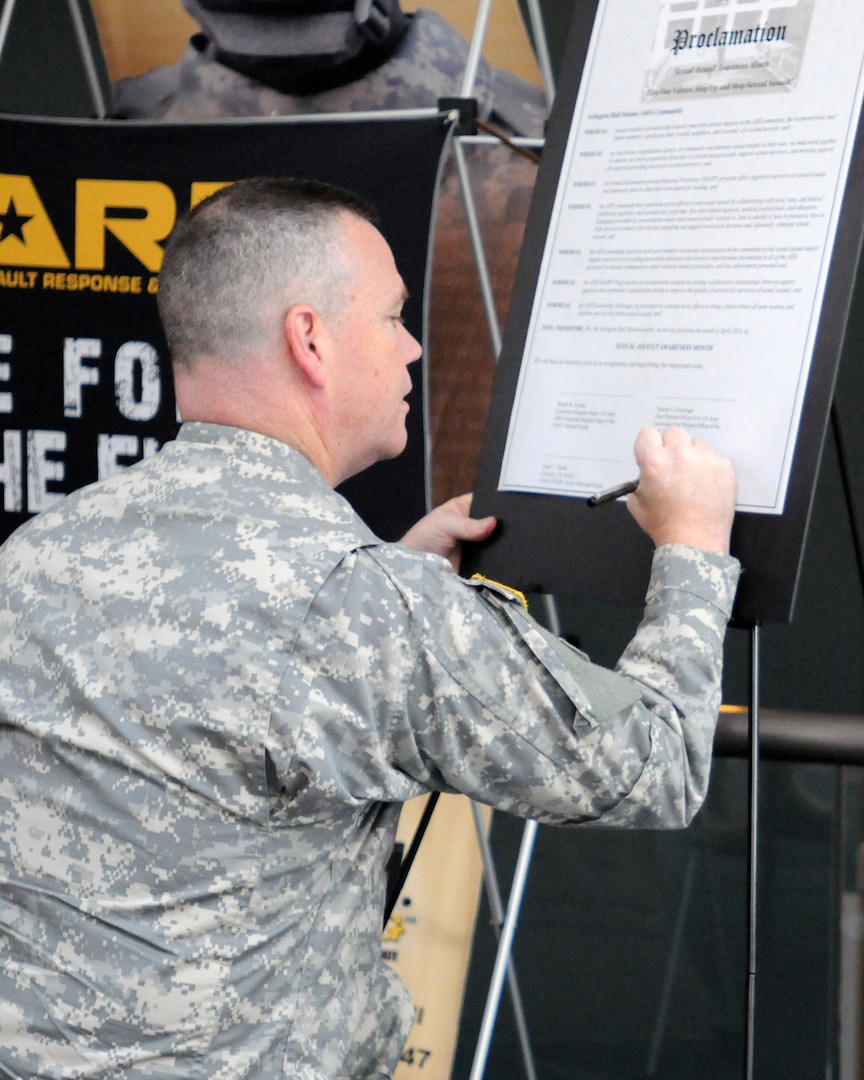 Army Maj. Gen. Judd Lyons, acting director of the Army National Guard, signs the Army National Guard Readiness Center’s sexual assault awareness proclamation, at the ARNGC, Arlington, Va., April 1, 2014.  The proclamation outlines ways National Guard members can reduce sexual harassment and prevent possible sexual assaults and is one part of the Guard's focus on reducing sexual assault within its ranks.