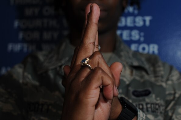 Airman 1st Class Shaney Scott does the American Sign Language sign for honor at the Enlisted Heritage Hall March 24, 2014, Maxwell Air Force Base, Ala. She is fluent in ASL and volunteers as a teacher and interpreter. Scott is a 690th Network Support Squadron enterprise service desk technician at Gunter Annex. (U.S. Air Force photo/Staff Sgt. Natasha Stannard)
 